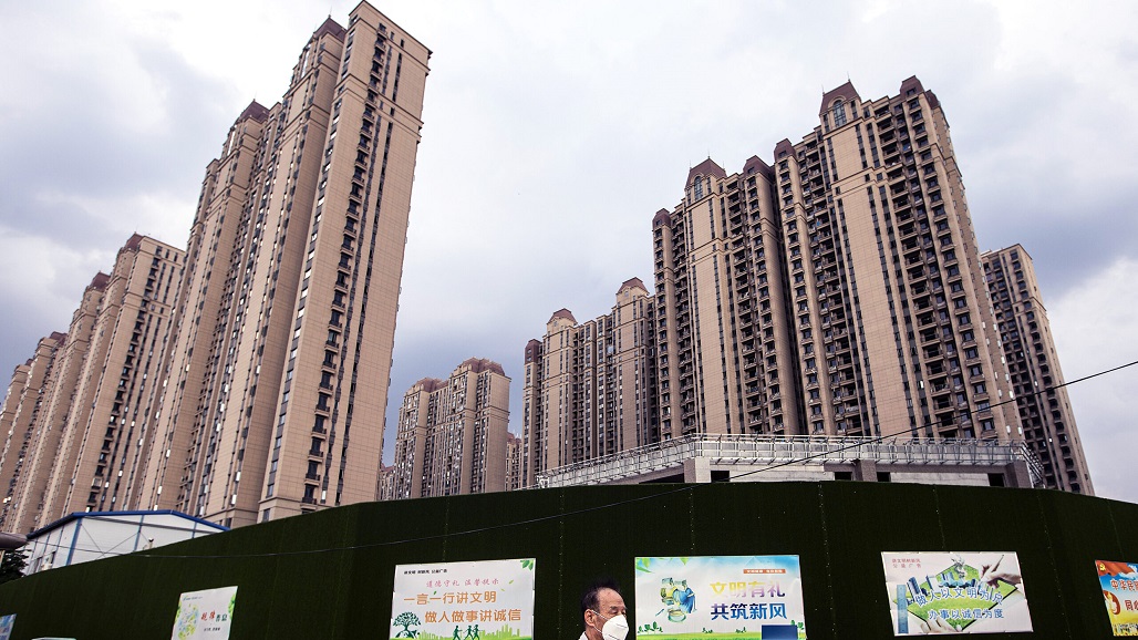 WUHAN, CHINA - SEPTEMBER 24: (CHINA OUT) A man wears a mask while walking through the Evergrande changqing community on September 24, 2021 in Wuhan, Hubei Province, China. In 2015, Evergrande real estate acquired four super large projects in Haikou, Wuhan and Huizhou, with a total construction area of nearly 4 million square meters and a total amount of 13.5 billion yuan. Evergrande, China's largest property developer, is facing a liquidity crisis with total debts of around $300 billion. The problems faced by the company could impact China’s economy, and the global economy at large.（Photo by Getty Images)