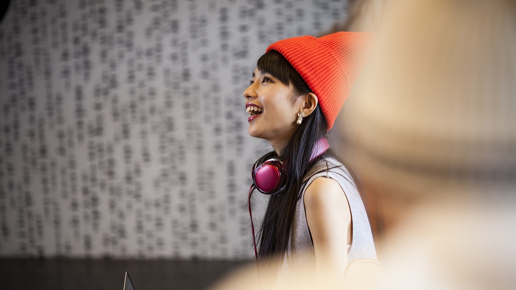 Young female start up business woman talking with colleague in office
